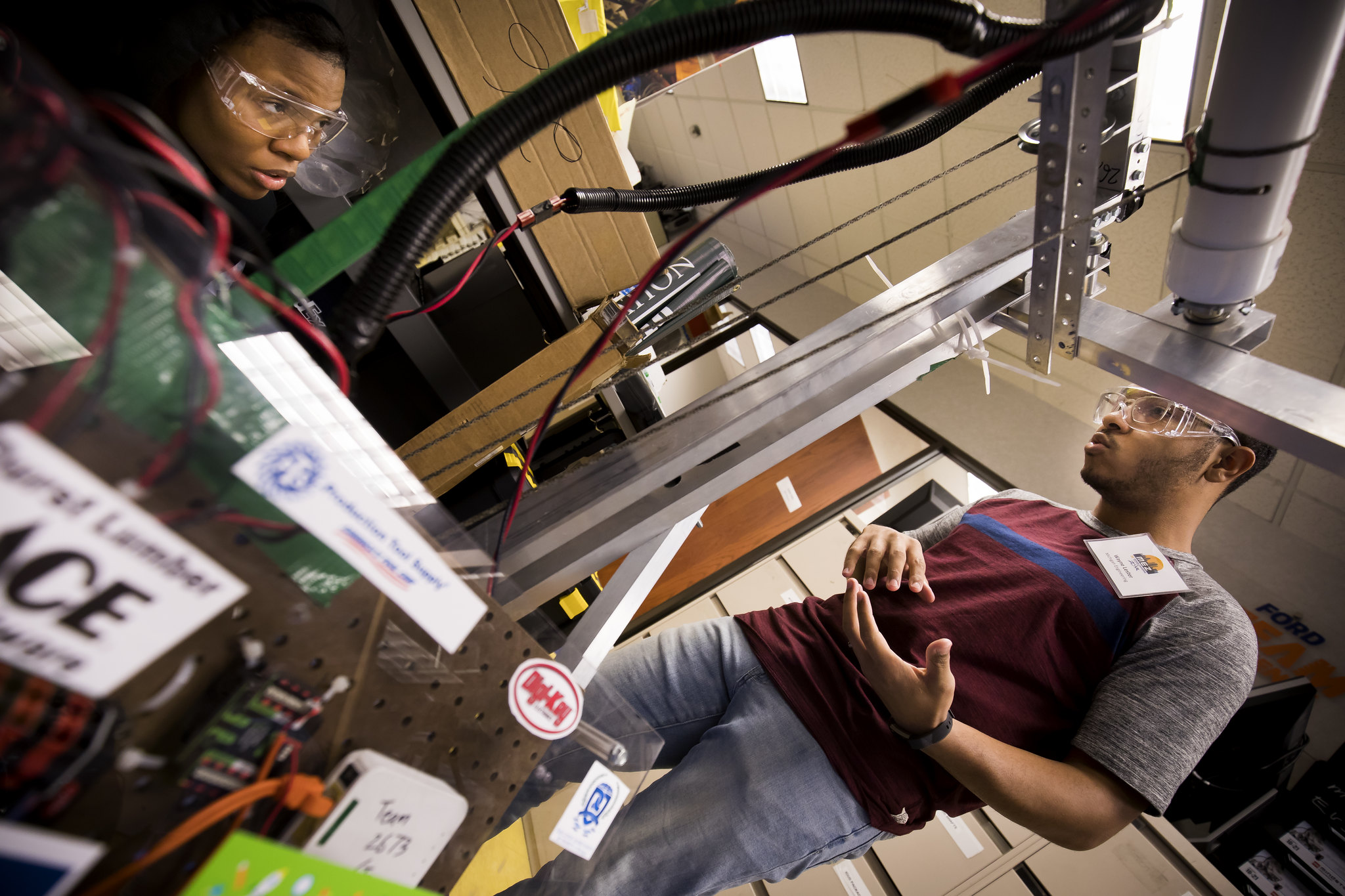 Two students working with machinery