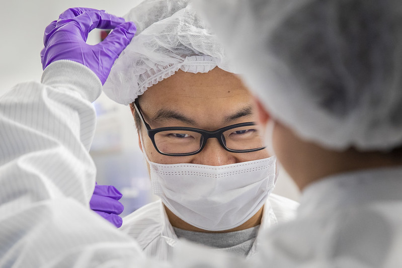 lab worker has PPE adjusted