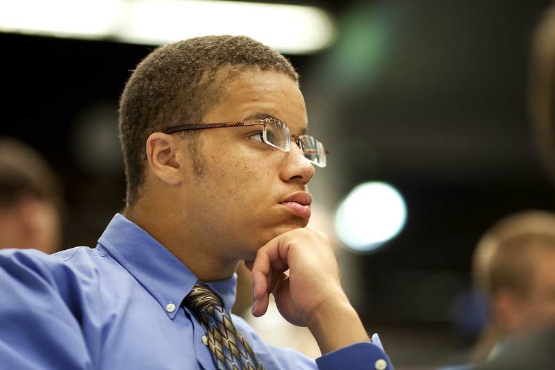 student listens to corporate speaker