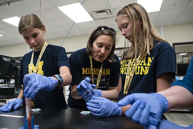 Woman and girl working together at a laboratory bench