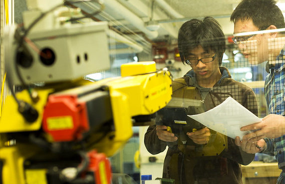 two researchers operating machinery