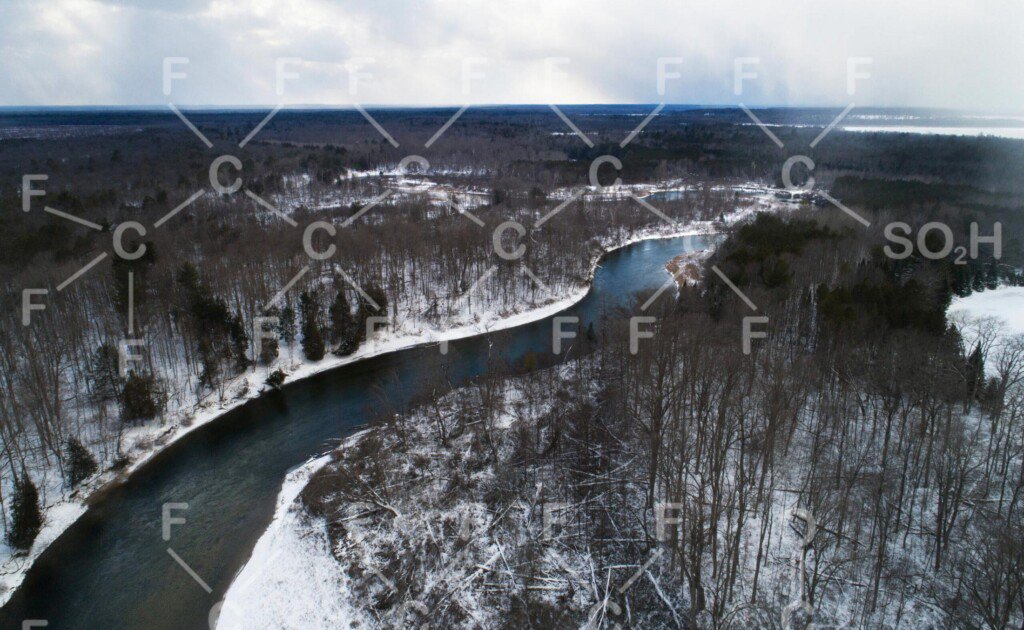 PFAS' atomic bonds overlay an image of a river