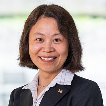 Mingyan Liu smiles and poses for a portrait.