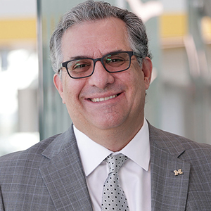 Steve Ceccio smiles and poses for a portrait in the Robotics building.