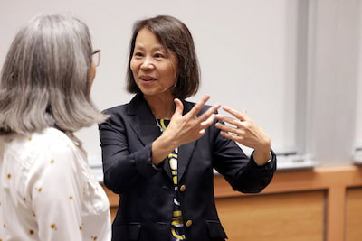 Mingyan Liu engages in conversation with a person. 